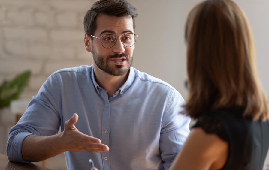 A professional man explains a business concept to a business student